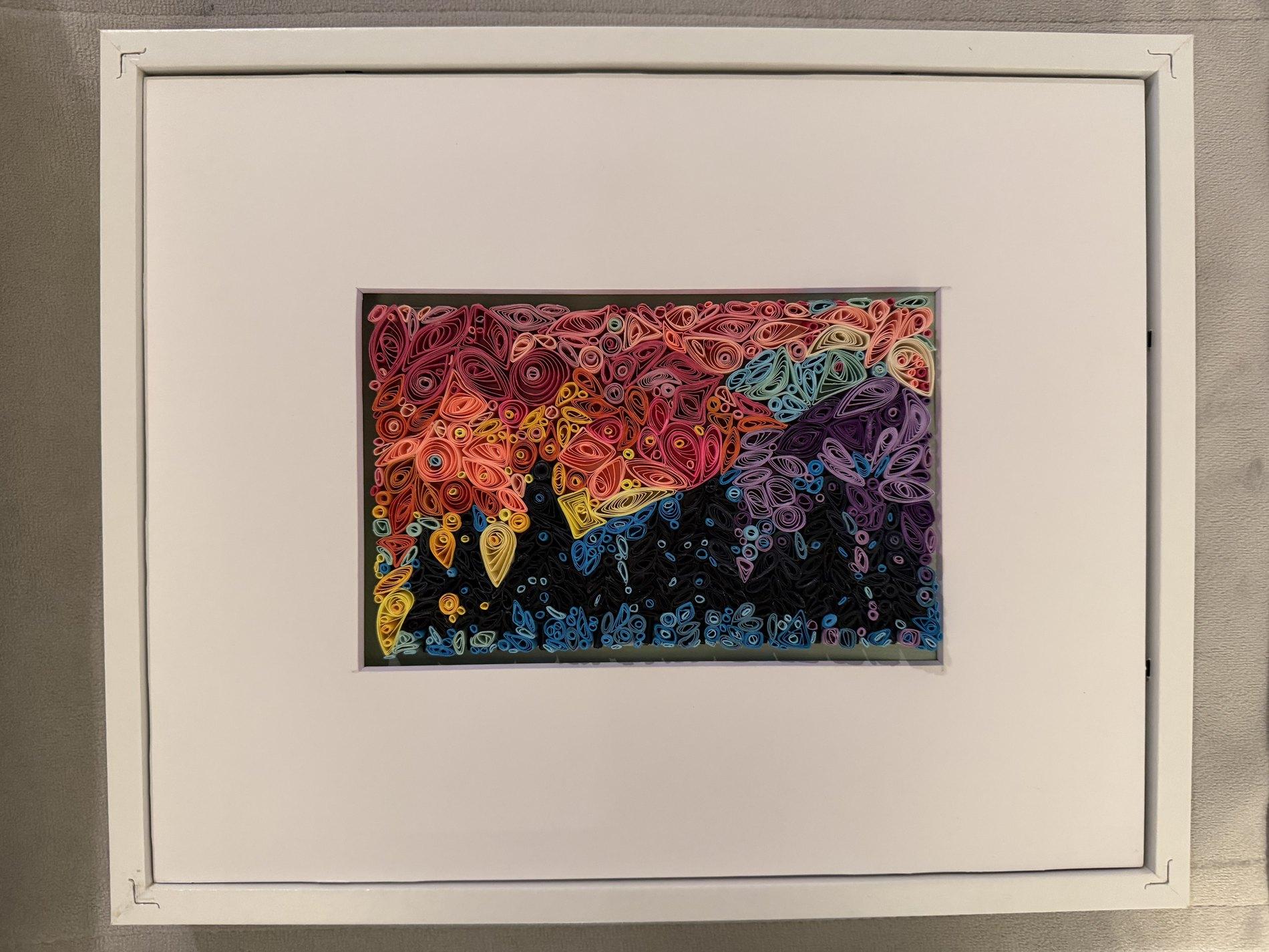 Colorful quilling artwork with floral and abstract paper shapes