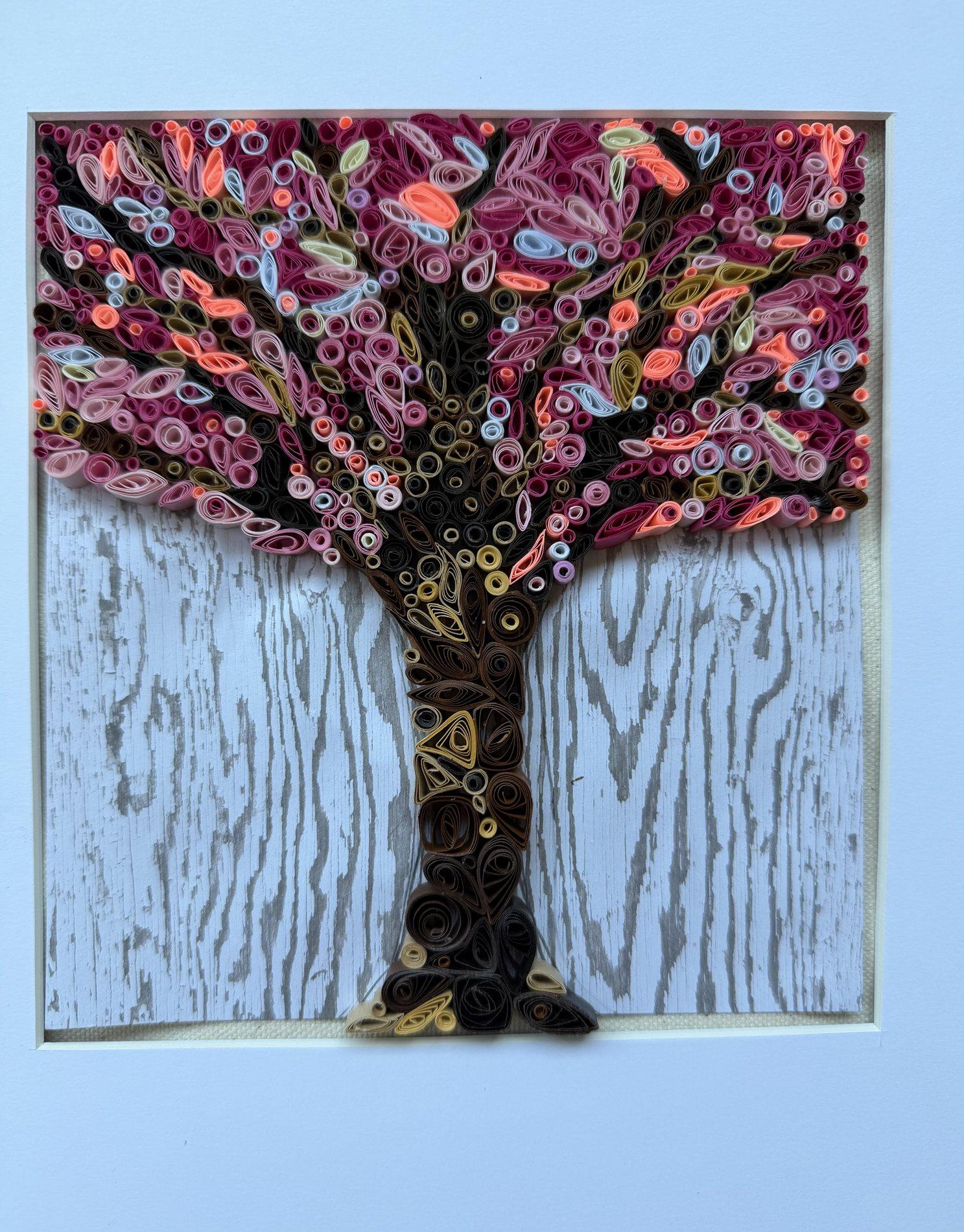 Pink flowering tree quilling artwork on a weathered white wood background
