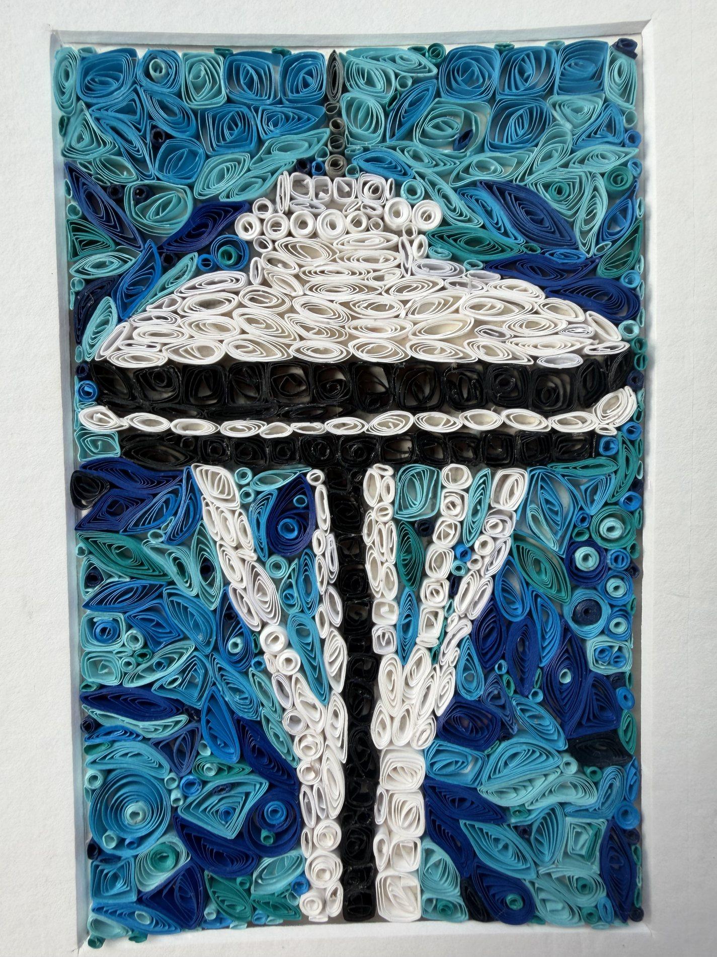 Seattle Space Needle quilling artwork in white and black paper against a blue background